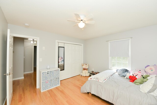 bedroom featuring light wood-type flooring, a closet, and a ceiling fan