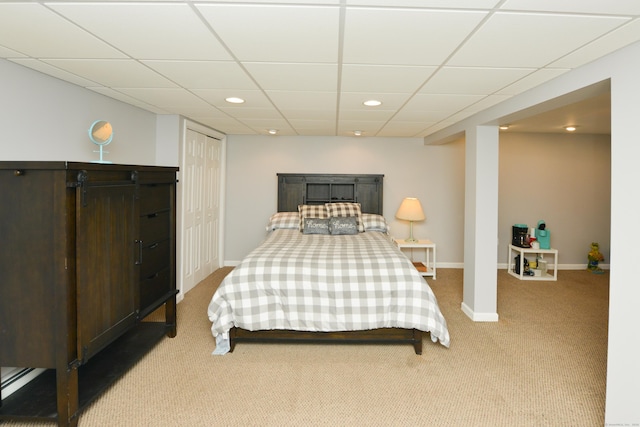 carpeted bedroom with a drop ceiling, recessed lighting, and baseboards