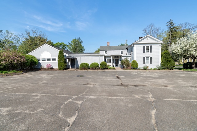 view of front of house featuring a chimney