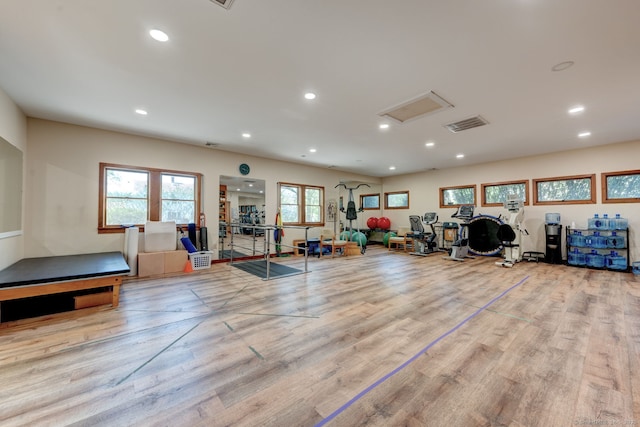 workout room featuring recessed lighting and wood finished floors
