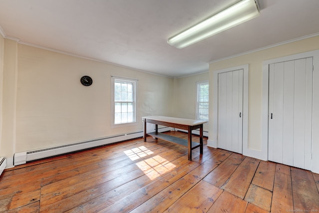 bedroom featuring light wood-type flooring, multiple windows, ornamental molding, multiple closets, and baseboard heating