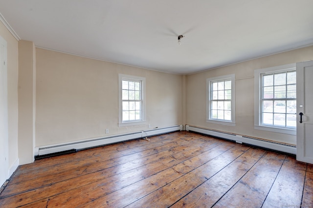 spare room featuring a baseboard radiator, hardwood / wood-style floors, and ornamental molding