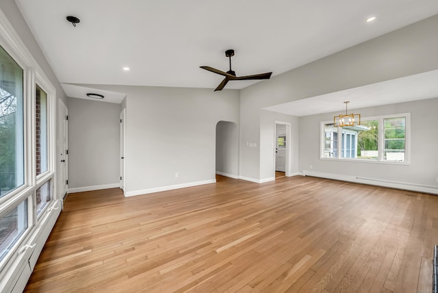 636 Thompson Rd, Thompson, CT 06277 - unfurnished living room featuring light wood-style flooring, ceiling fan, baseboards, a chandelier, and lofted ceiling