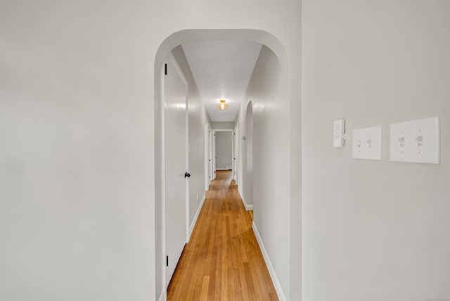 636 Thompson Rd, Thompson, CT 06277 - hallway with arched walkways, light wood-style flooring, and baseboards