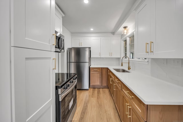 636 Thompson Rd, Thompson, CT 06277 - kitchen with appliances with stainless steel finishes, a sink, recessed lighting, light wood-type flooring, and light countertops