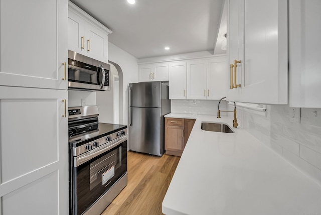 636 Thompson Rd, Thompson, CT 06277 - kitchen with appliances with stainless steel finishes, a sink, light countertops, decorative backsplash, and white cabinetry