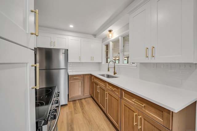 636 Thompson Rd, Thompson, CT 06277 - kitchen featuring a sink, appliances with stainless steel finishes, tasteful backsplash, light countertops, and light wood finished floors