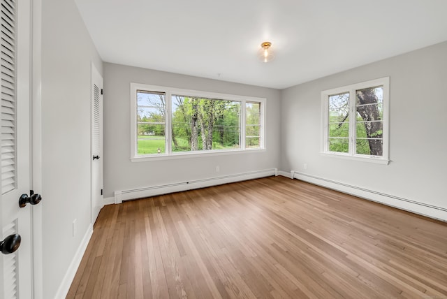 636 Thompson Rd, Thompson, CT 06277 - unfurnished bedroom with baseboard heating, multiple windows, light wood-type flooring, and baseboards