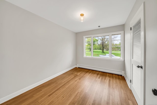 636 Thompson Rd, Thompson, CT 06277 - unfurnished bedroom featuring a baseboard radiator, baseboards, and light wood-style flooring