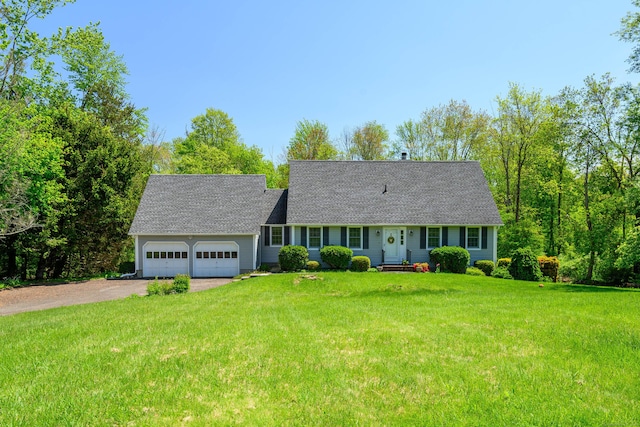 cape cod house with driveway, roof with shingles, an attached garage, and a front lawn