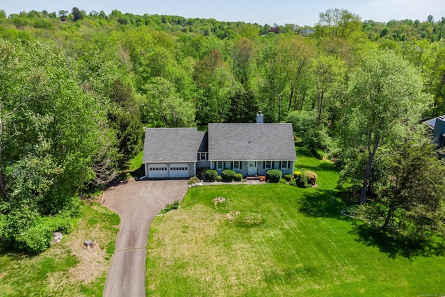 view of subject property featuring a heavily wooded area