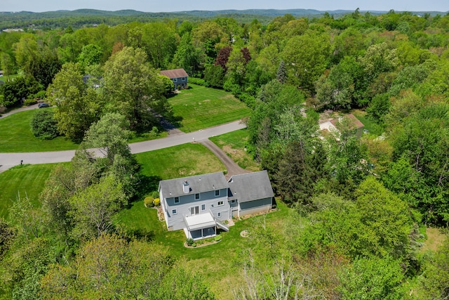 view of subject property featuring a heavily wooded area