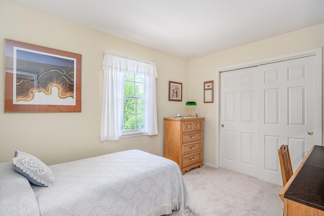 carpeted bedroom featuring a closet