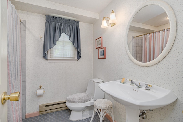 bathroom featuring baseboard heating and toilet