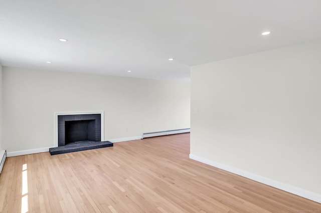 192 Morgan Cir, Wethersfield, CT 06109 - unfurnished living room with a baseboard heating unit, light wood finished floors, baseboards, a fireplace, and recessed lighting
