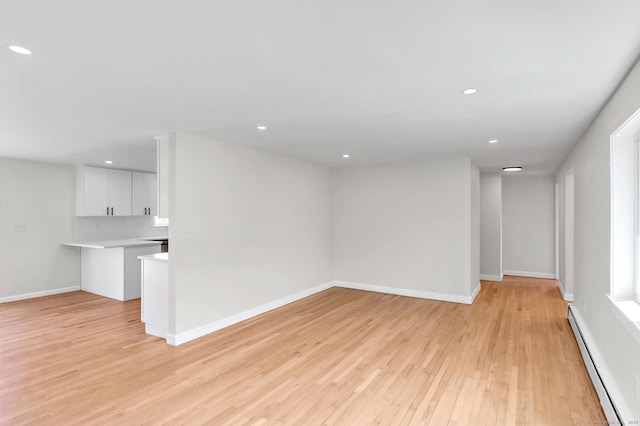 192 Morgan Cir, Wethersfield, CT 06109 - unfurnished living room featuring a baseboard heating unit, light wood finished floors, recessed lighting, and baseboards