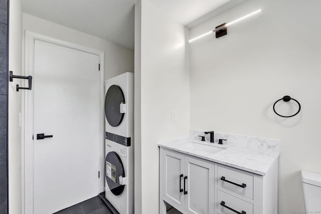 192 Morgan Cir, Wethersfield, CT 06109 - bathroom with stacked washing machine and dryer, toilet, and vanity