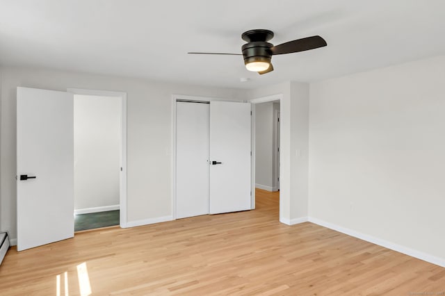 192 Morgan Cir, Wethersfield, CT 06109 - unfurnished bedroom with light wood-style floors, baseboards, baseboard heating, and a ceiling fan