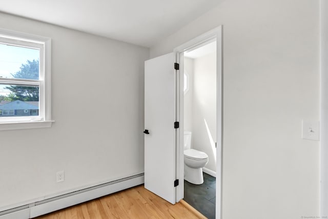192 Morgan Cir, Wethersfield, CT 06109 - unfurnished bedroom with baseboard heating, light wood finished floors, and ensuite bath