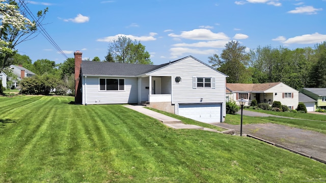 192 Morgan Cir, Wethersfield, CT 06109 - view of front of home featuring a garage, a chimney, asphalt driveway, and a front yard