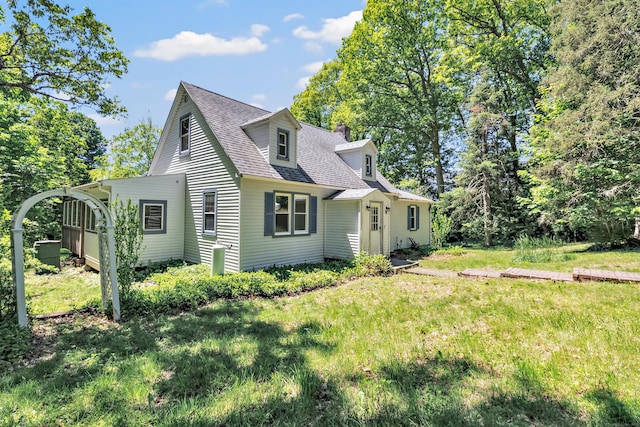 13 Hoyt Rd, Bethel, CT 06801 - view of home's exterior with a shingled roof, a lawn, and a chimney