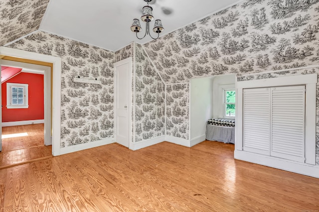13 Hoyt Rd, Bethel, CT 06801 - spare room with wood finished floors, vaulted ceiling, baseboards, and wallpapered walls