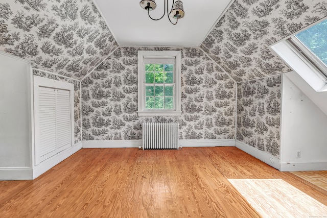 13 Hoyt Rd, Bethel, CT 06801 - additional living space with radiator, wood finished floors, vaulted ceiling, baseboards, and wallpapered walls