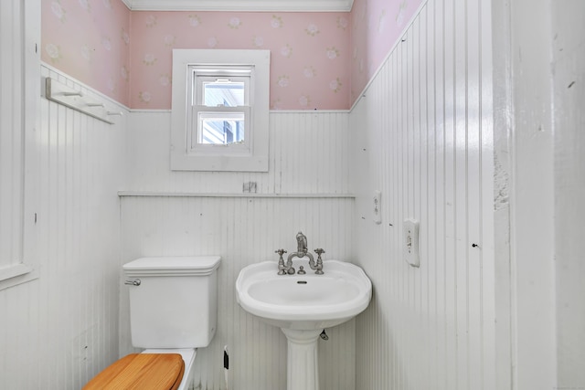 13 Hoyt Rd, Bethel, CT 06801 - half bathroom with wallpapered walls, toilet, and a wainscoted wall