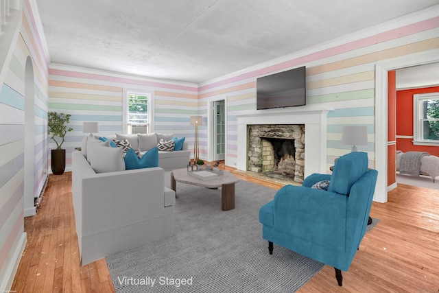 13 Hoyt Rd, Bethel, CT 06801 - living area with crown molding, hardwood / wood-style floors, a fireplace, wallpapered walls, and healthy amount of natural light