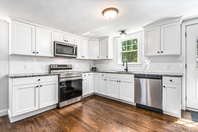 17 Emily Rd, East Windsor, CT 06016 - kitchen featuring stainless steel appliances, dark wood-style flooring, a sink, and dark stone counters