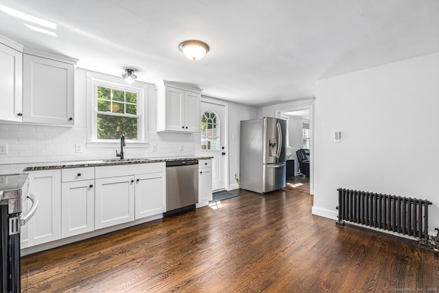 17 Emily Rd, East Windsor, CT 06016 - kitchen with radiator heating unit, appliances with stainless steel finishes, a sink, dark wood-style floors, and dark stone counters