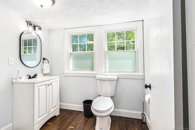 17 Emily Rd, East Windsor, CT 06016 - bathroom with baseboards, a textured ceiling, wood finished floors, toilet, and vanity