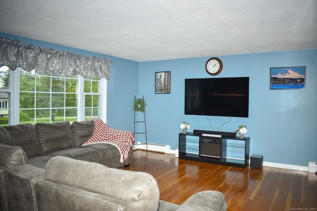 living area featuring a baseboard heating unit, wood finished floors, baseboards, and a textured ceiling