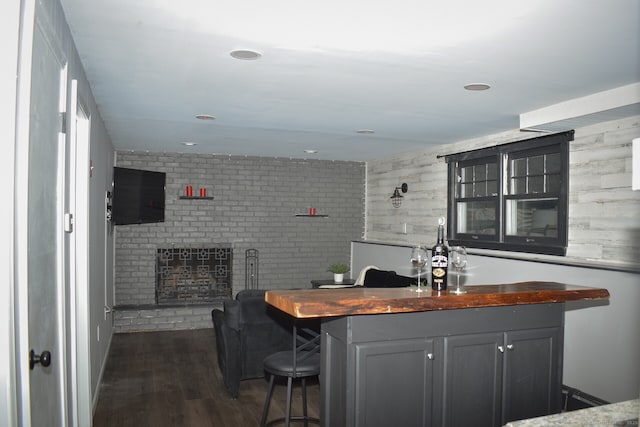 bar featuring dark wood-type flooring and recessed lighting