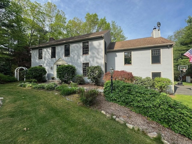 9 Pheasant Run, Granby, CT 06060 - colonial house featuring a chimney and a front yard