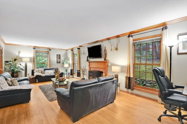 9 Pheasant Run, Granby, CT 06060 - living area with ornamental molding, a brick fireplace, light wood-style floors, an office area, and baseboards