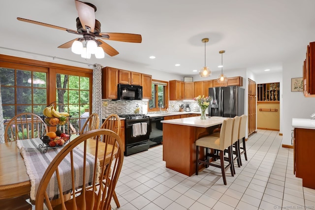 9 Pheasant Run, Granby, CT 06060 - kitchen with black appliances, light countertops, plenty of natural light, a sink, and recessed lighting