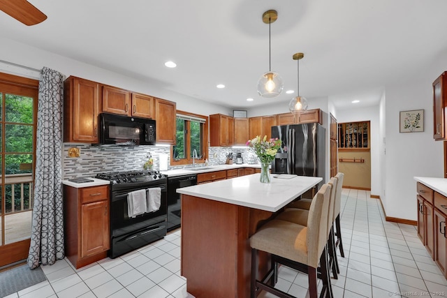 9 Pheasant Run, Granby, CT 06060 - kitchen featuring black appliances, backsplash, light countertops, a kitchen bar, and recessed lighting