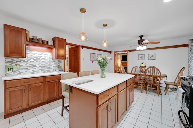 9 Pheasant Run, Granby, CT 06060 - kitchen featuring tasteful backsplash, light countertops, light tile patterned floors, and a kitchen breakfast bar