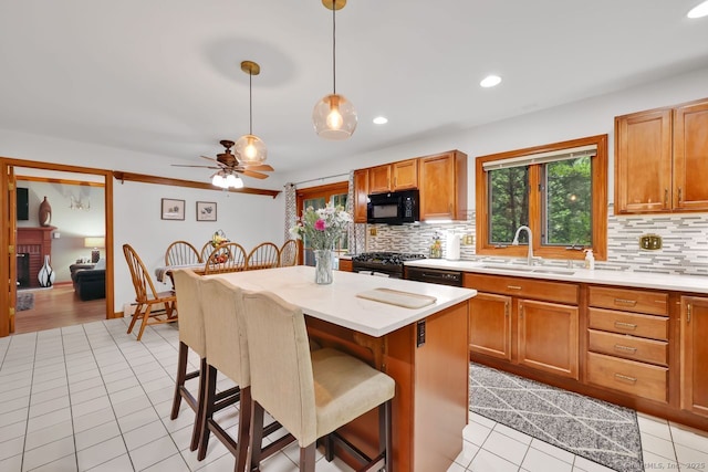 9 Pheasant Run, Granby, CT 06060 - kitchen featuring black appliances, a sink, decorative backsplash, light tile patterned floors, and a kitchen breakfast bar
