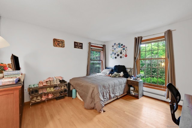 9 Pheasant Run, Granby, CT 06060 - bedroom featuring multiple windows, light wood-type flooring, and a baseboard heating unit