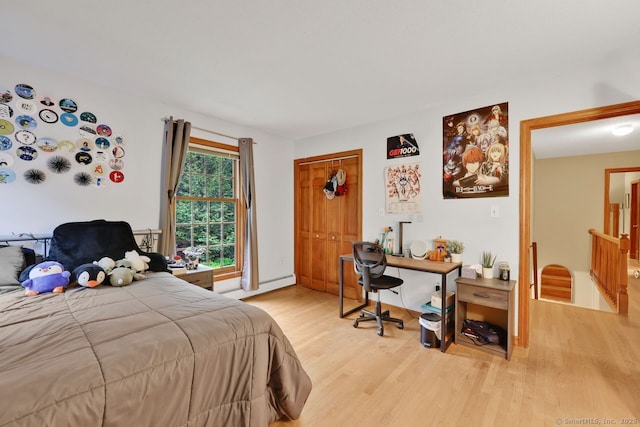 9 Pheasant Run, Granby, CT 06060 - bedroom featuring a baseboard heating unit, light wood-style floors, an office area, and a closet