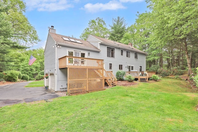 9 Pheasant Run, Granby, CT 06060 - rear view of house with a chimney, a wooden deck, driveway, and a lawn