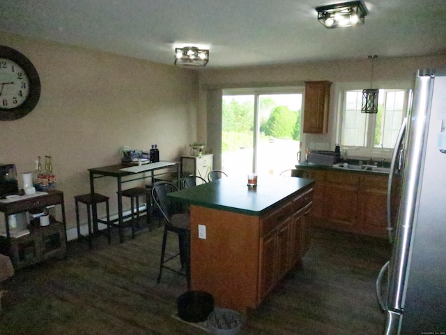 23 Hell Hollow Rd, Sterling, CT 06384 - kitchen with freestanding refrigerator, brown cabinets, dark wood-style flooring, and a kitchen island