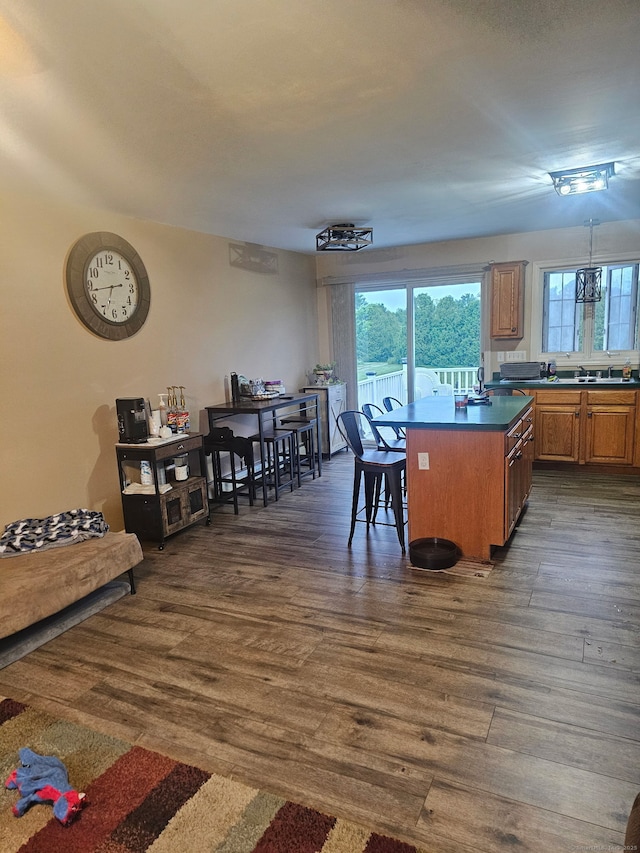 23 Hell Hollow Rd, Sterling, CT 06384 - kitchen with dark wood finished floors, healthy amount of natural light, brown cabinetry, and dark countertops