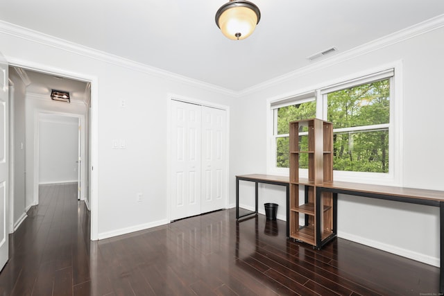 unfurnished office featuring baseboards, crown molding, and dark wood-style flooring