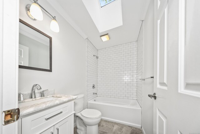 bathroom featuring toilet, vanity, washtub / shower combination, and a skylight