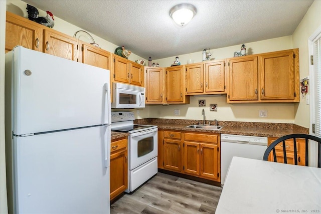 40 Glen Ridge Ct Unit 40, New Milford, CT 06776 - kitchen featuring white appliances, a sink, light wood-type flooring, dark countertops, and a textured ceiling