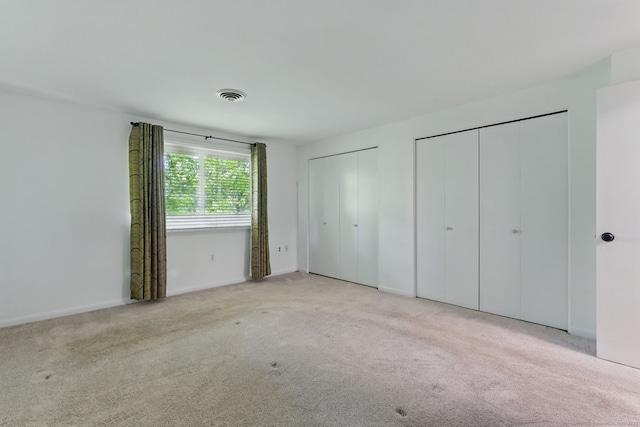 404 Cedar Hollow Dr Unit 404, Rocky Hill, CT 06067 - unfurnished bedroom with two closets, carpet floors, and baseboards