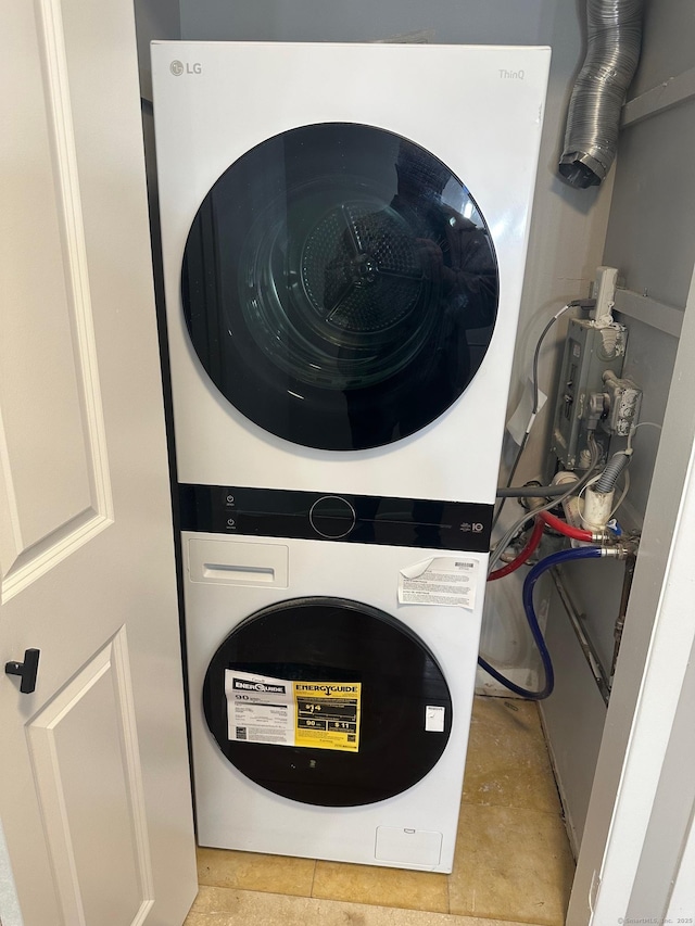 laundry room with stacked washer / drying machine